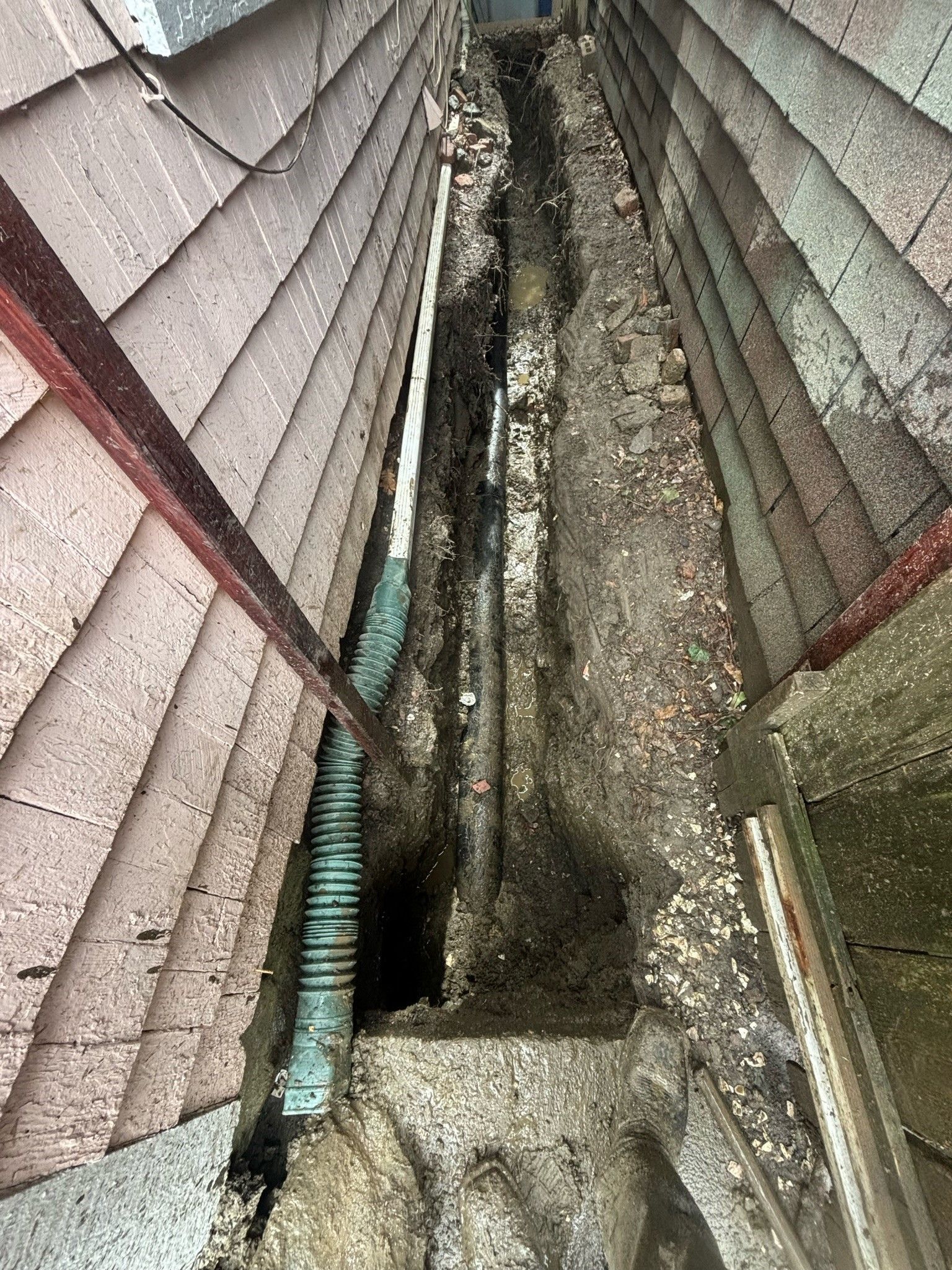 A hole in the roof of a building with a pipe coming out of it.