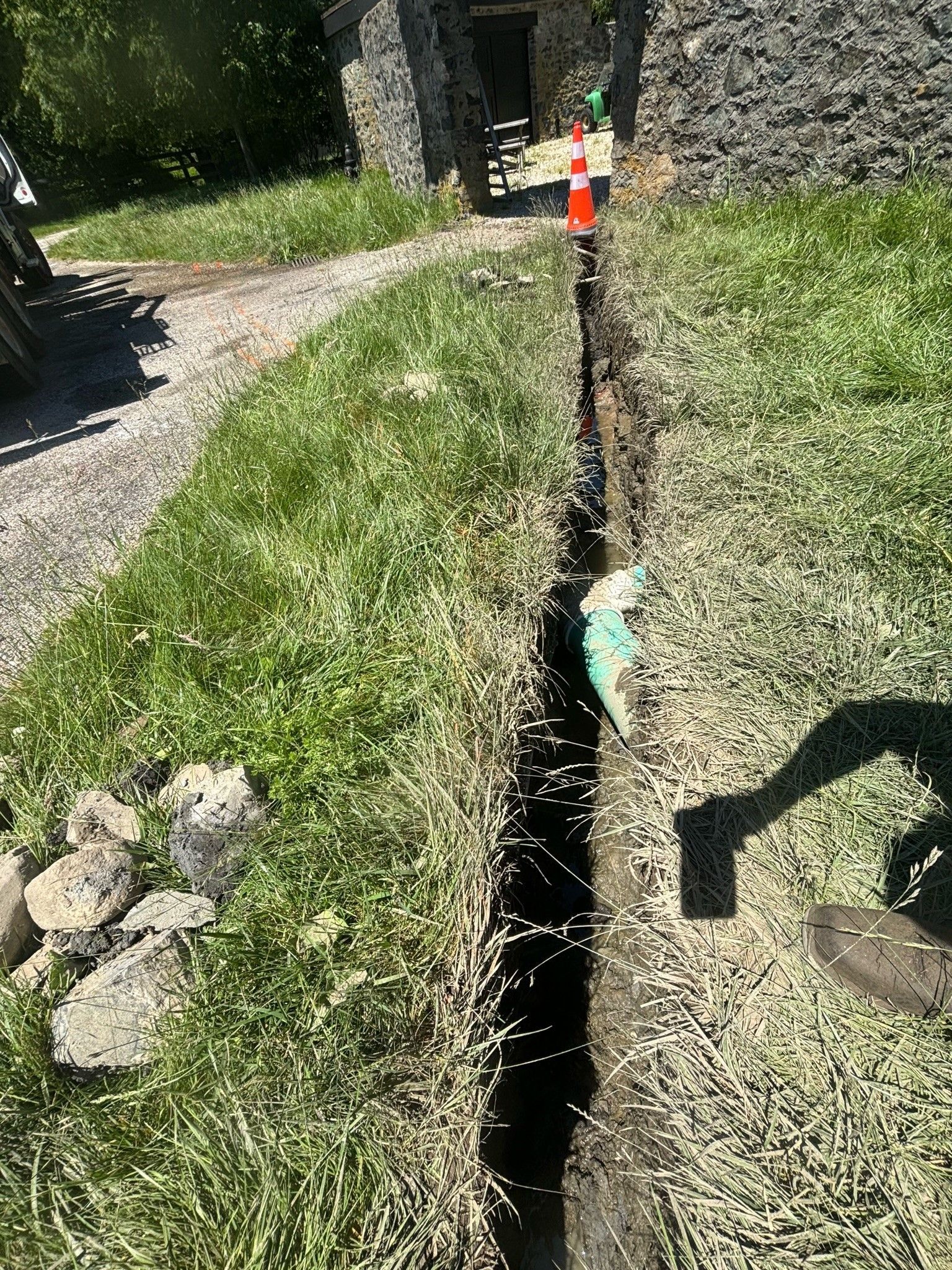 A person is digging a hole in the ground in a yard.