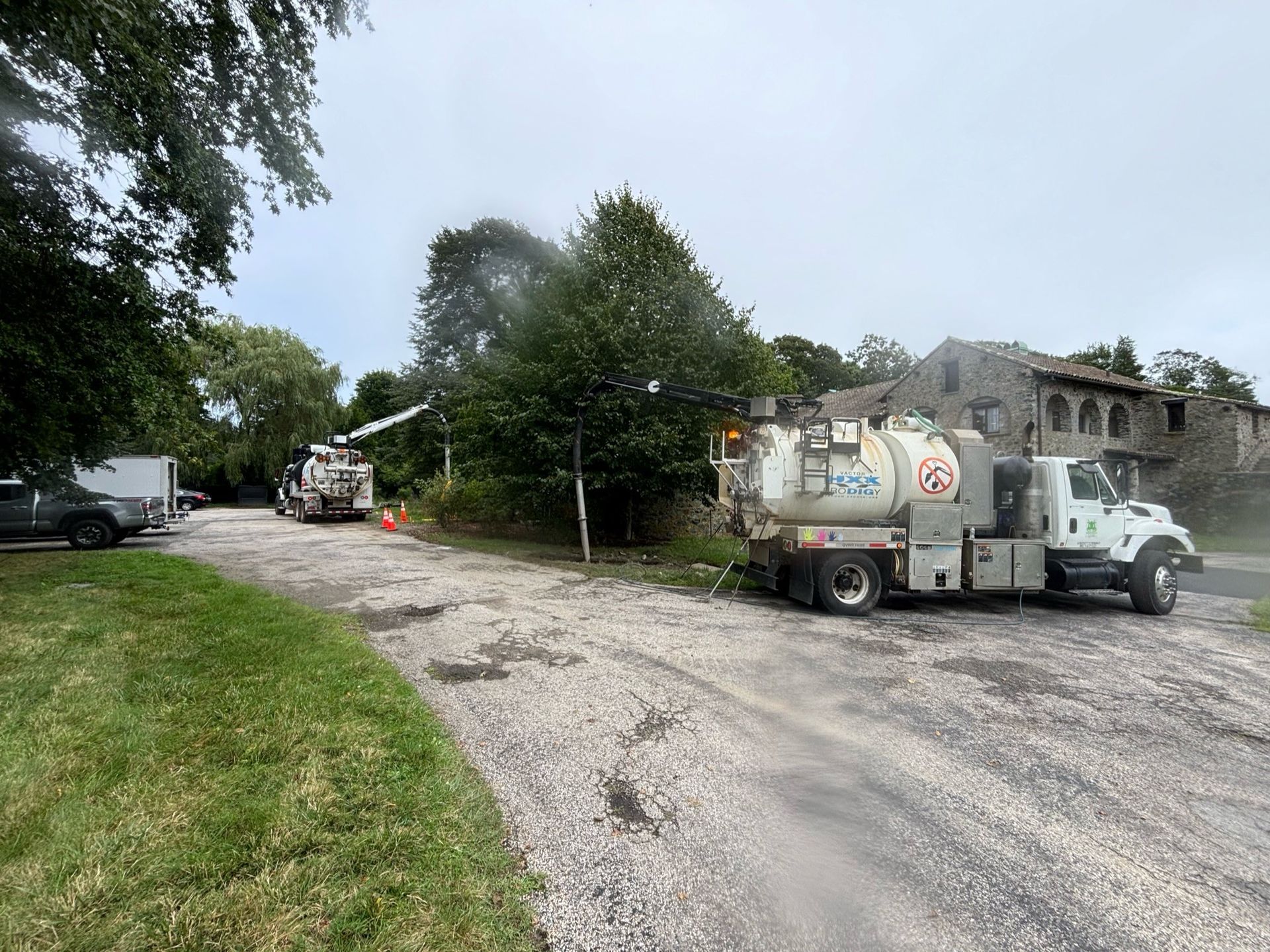 A vacuum truck is parked on the side of the road.