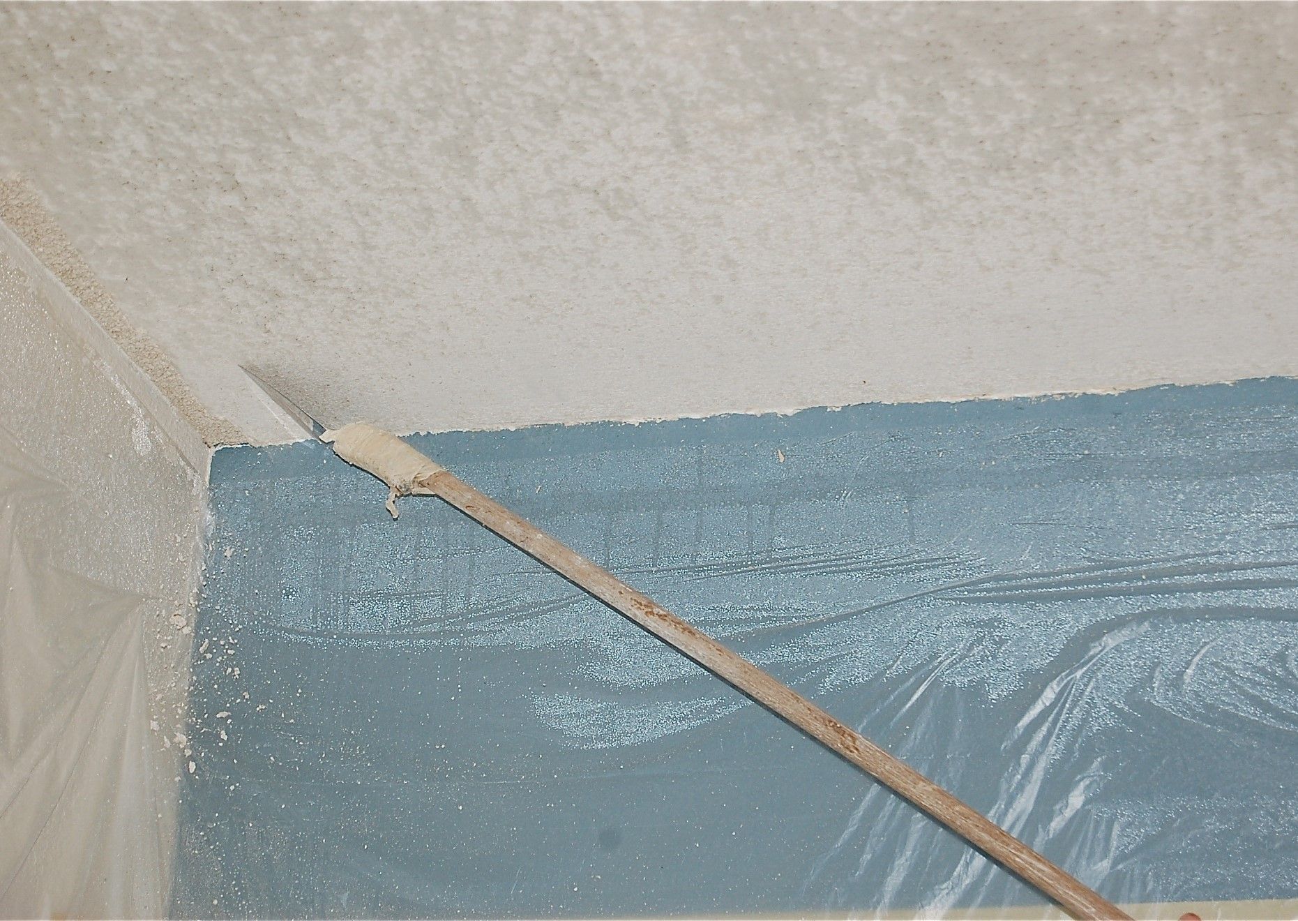 A person is painting a wall with a brush