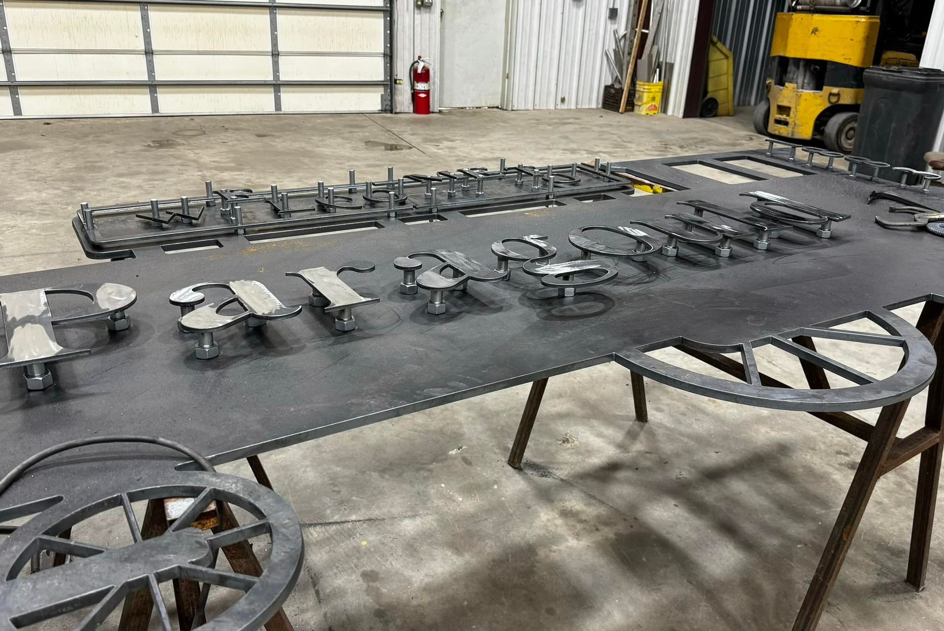 A large metal sign is sitting on top of a wooden table.