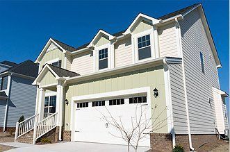 A large house with a large garage and stairs