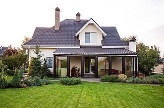 A large house with a large lawn in front of it.