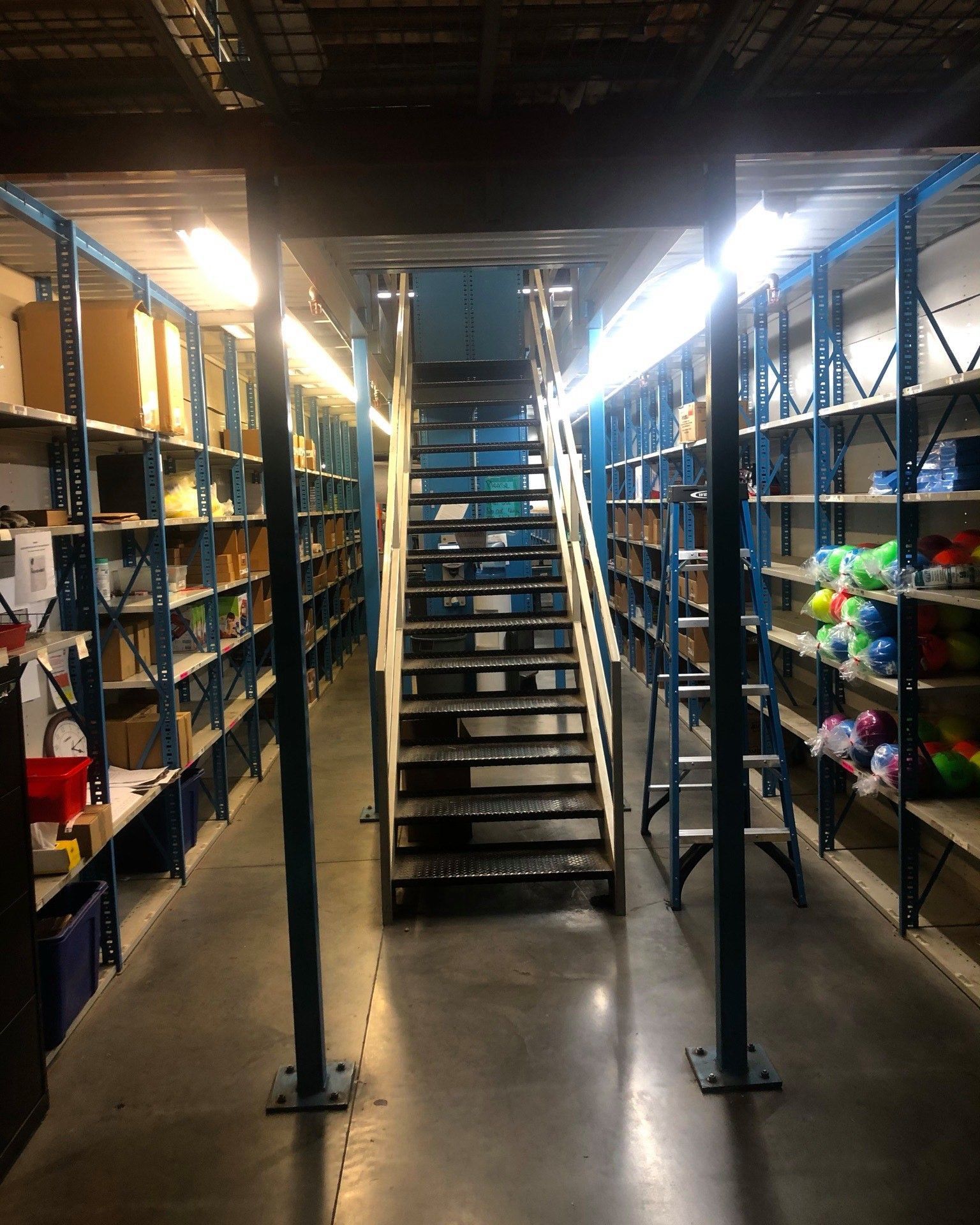 A warehouse with stairs leading up to the second floor