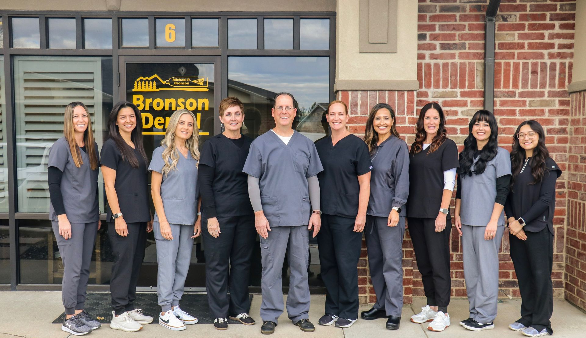 Staff of Bronson Dental standing outside their office.
