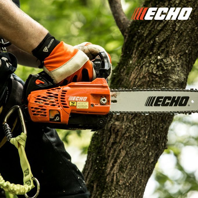 A person is using an echo chainsaw to cut a tree