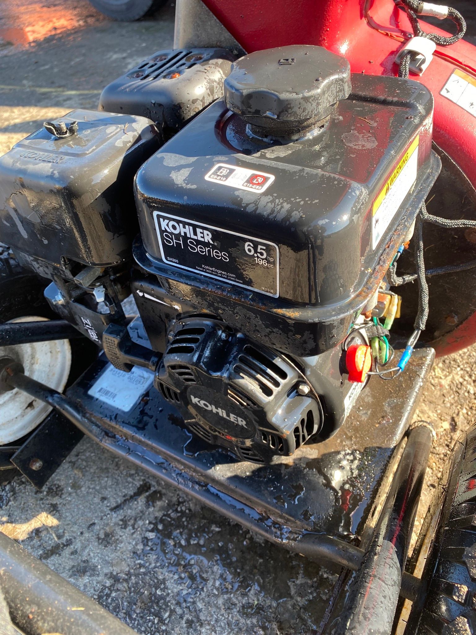 A close up of a gas engine on a snow blower.