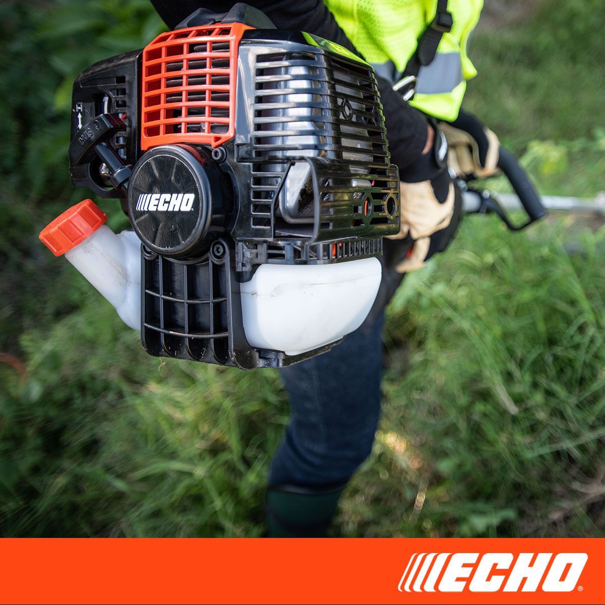 A person is holding a echo brush cutter in their hand