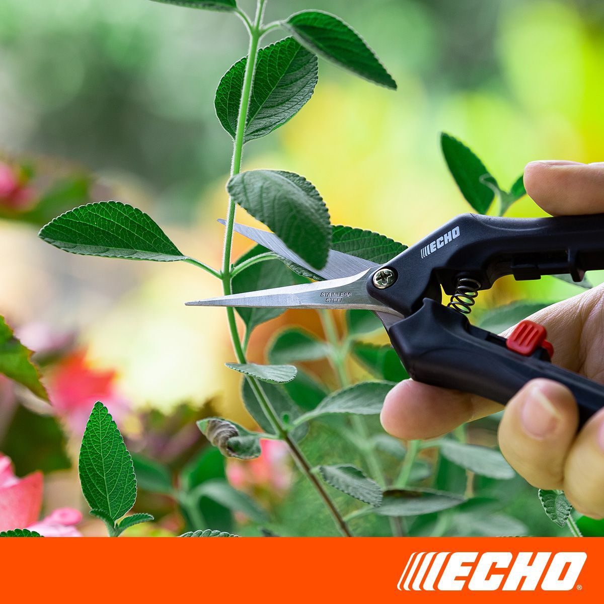 A person is cutting a plant with a pair of echo scissors