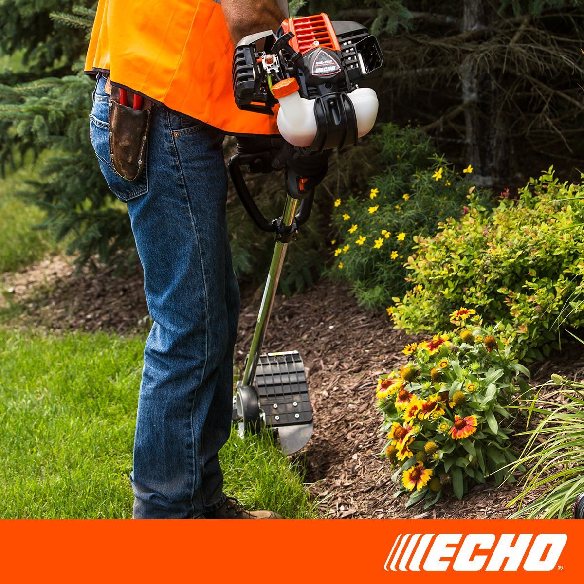 A man is using a echo lawn mower to cut the grass.