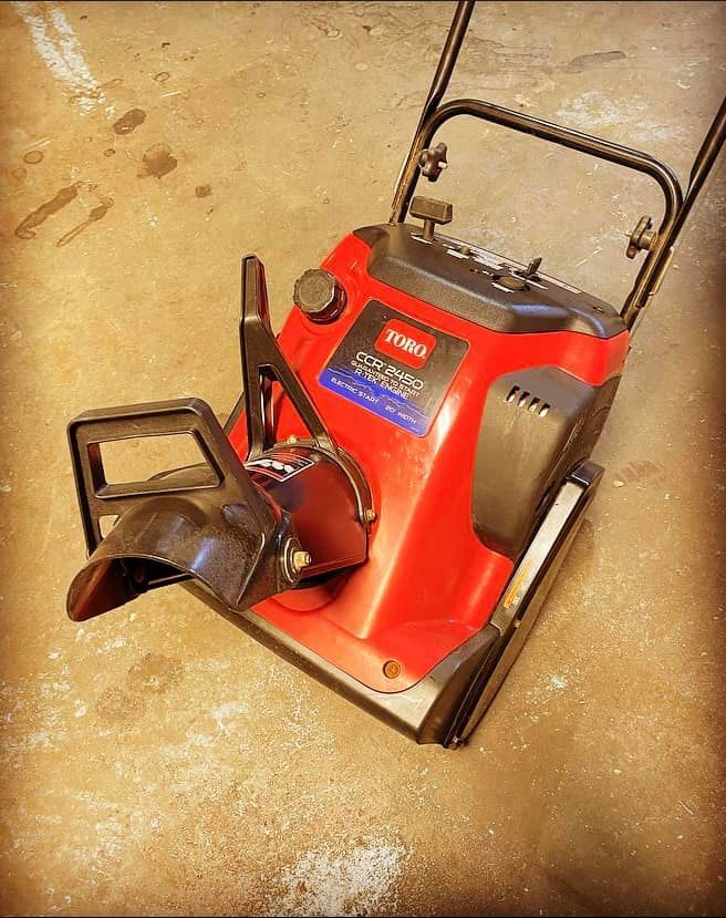 A toro snow blower is sitting on the ground