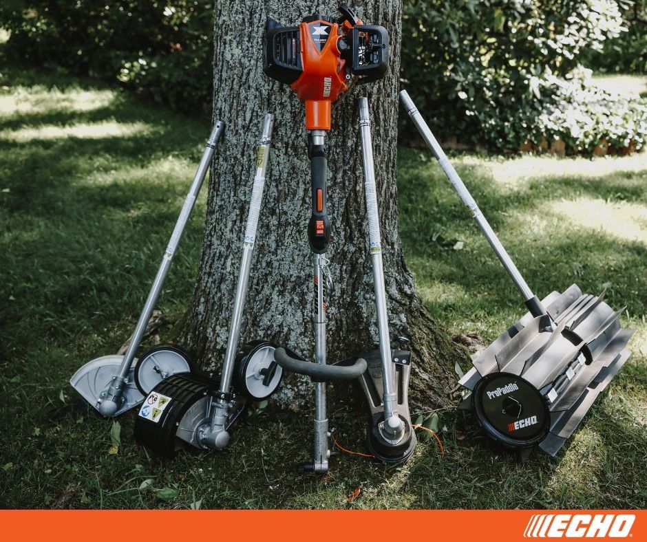 A lawn mower is leaning against a tree in the grass