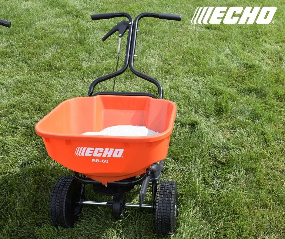 An echo spreader is sitting on top of a lush green lawn