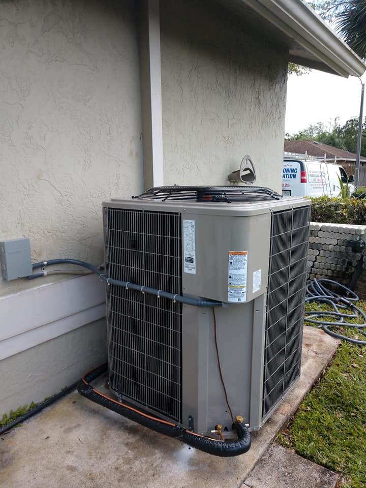 A large cooling unit sitting on the side of a house.