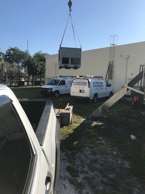 Cooling unit being lowered into place with a crane