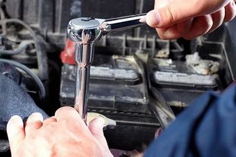 A man is fixing a car.