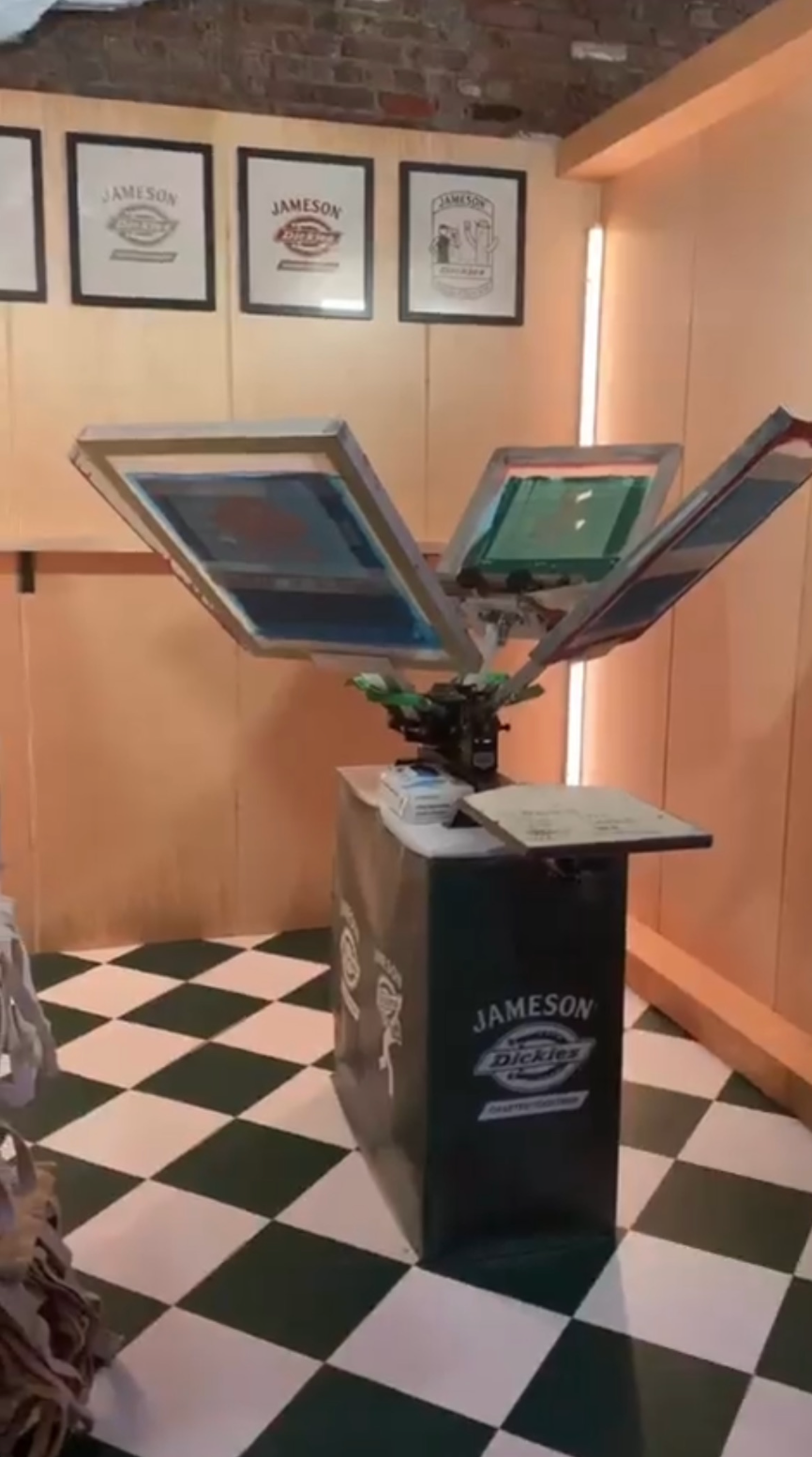 a room with a checkered floor and a desk with a Dickies logo on it