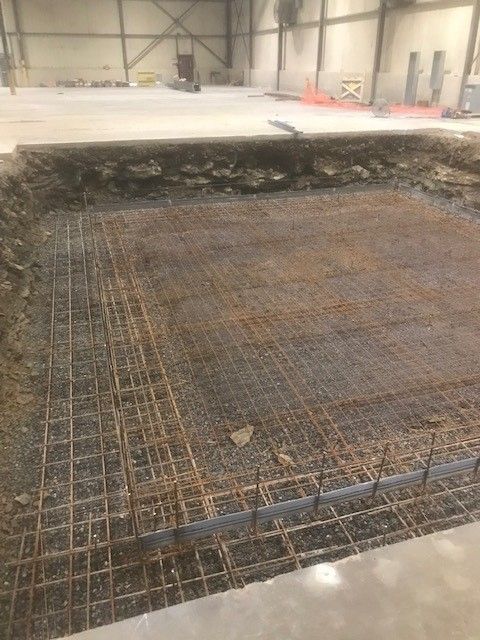 A large concrete slab is being built in a building.