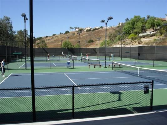 A man is playing tennis on a tennis court