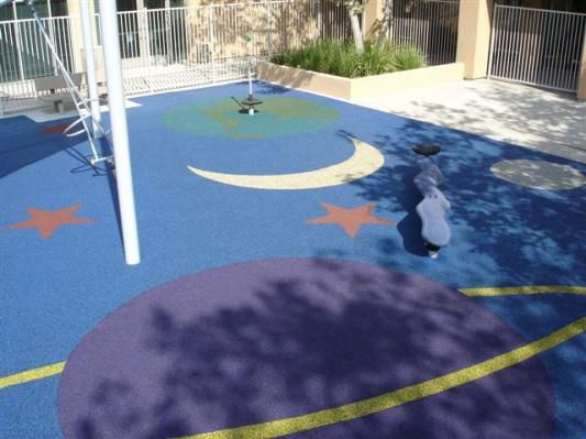 A playground with a crescent moon and stars painted on the floor