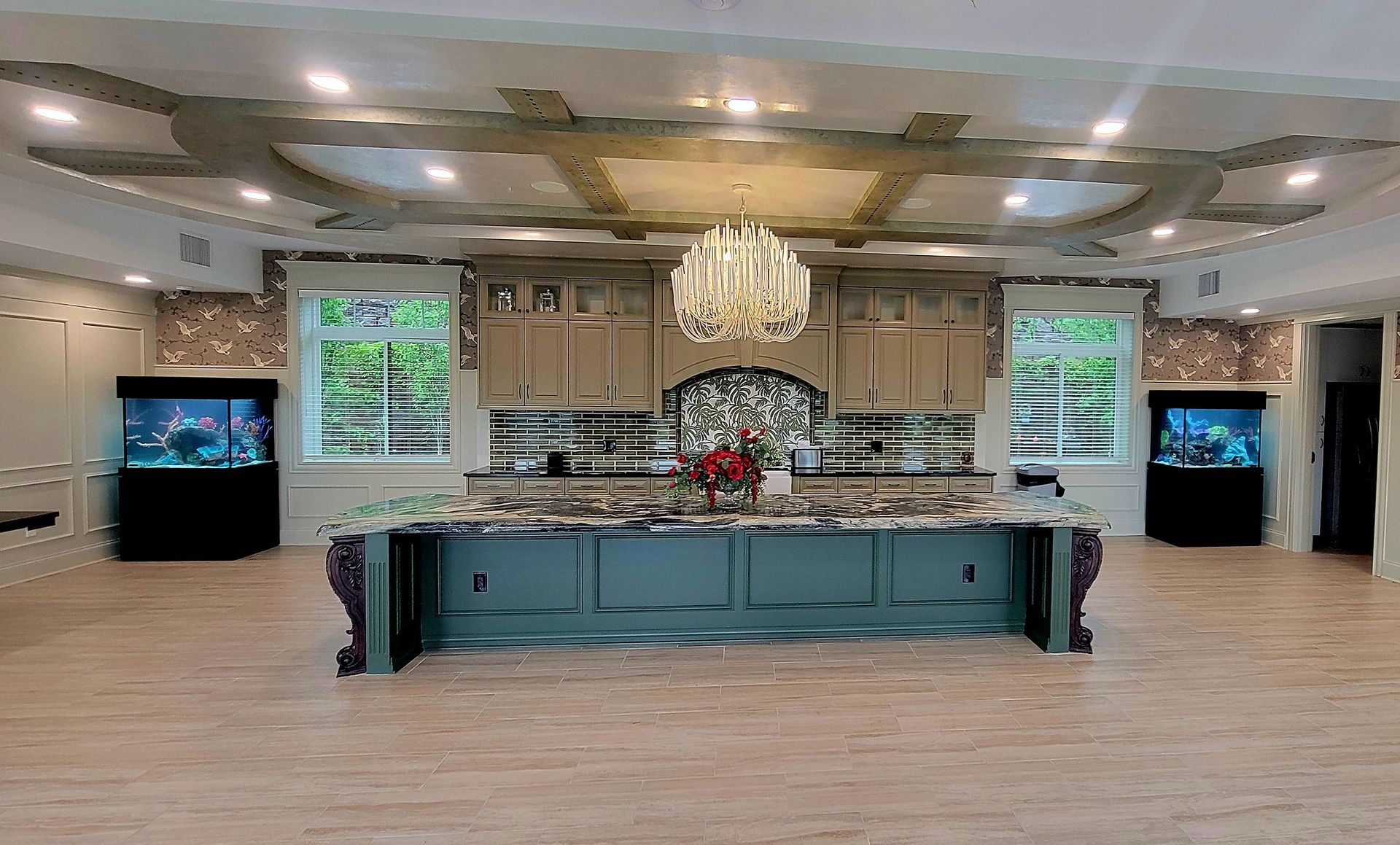 A large kitchen with a large island and a chandelier.