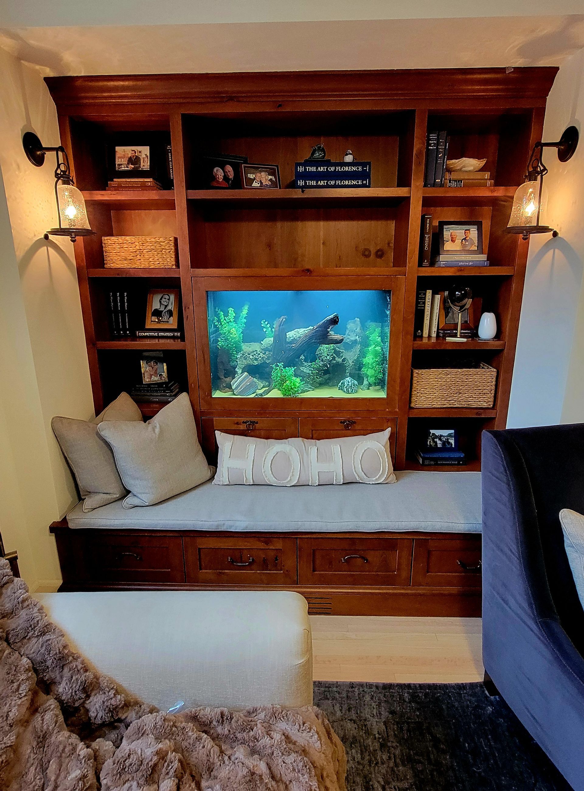 A living room with a fish tank in the corner