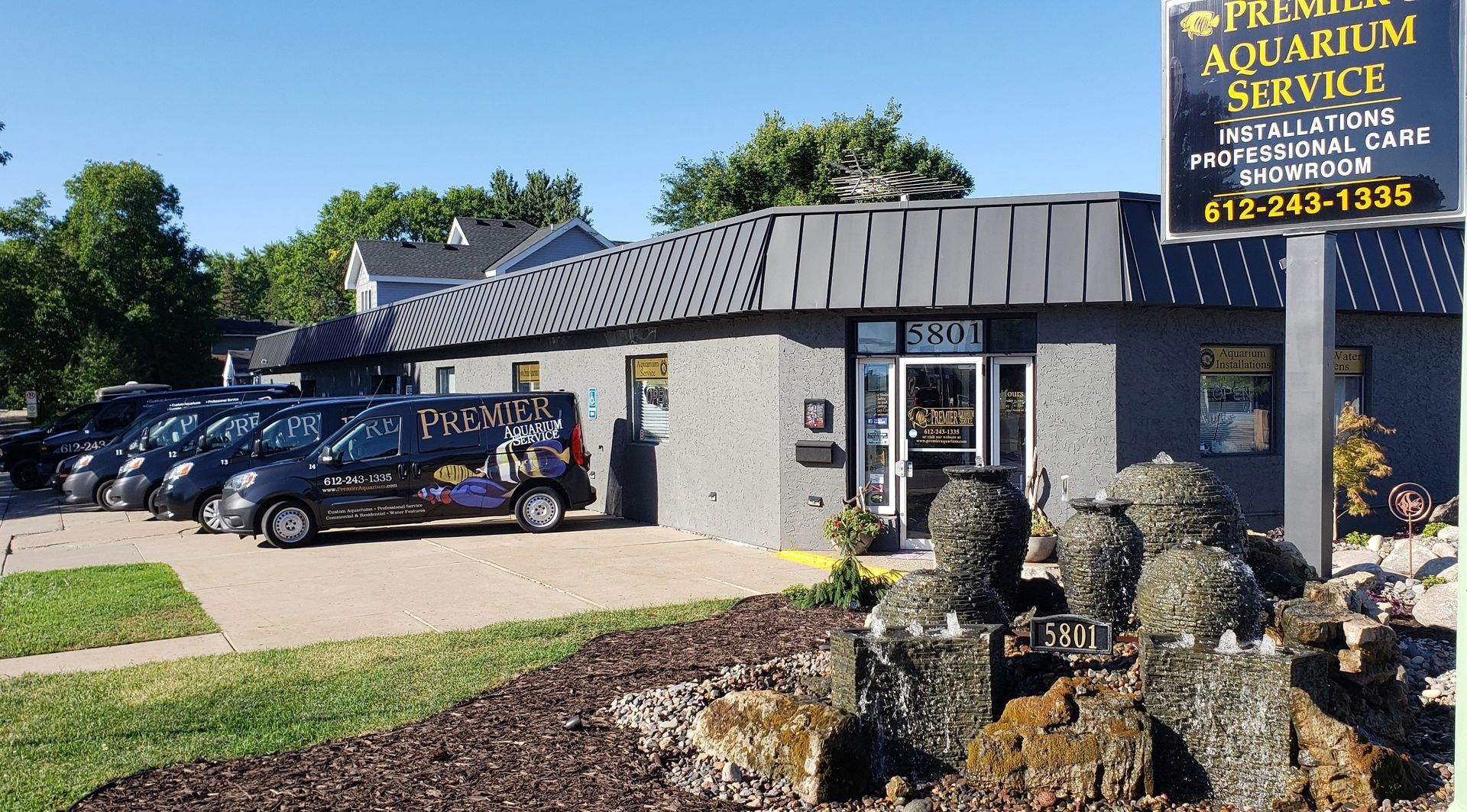 Premier Aquarium Service - business entrance with fleet of vans parked in front