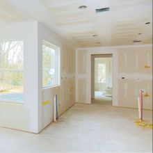 A room that is being remodeled with drywall and a window.