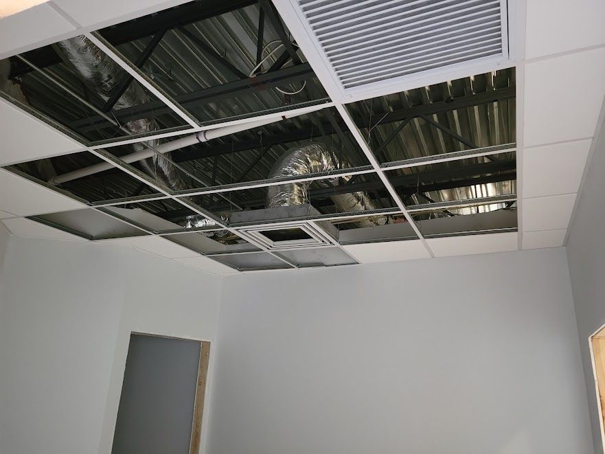 A room with a ceiling that has holes in it