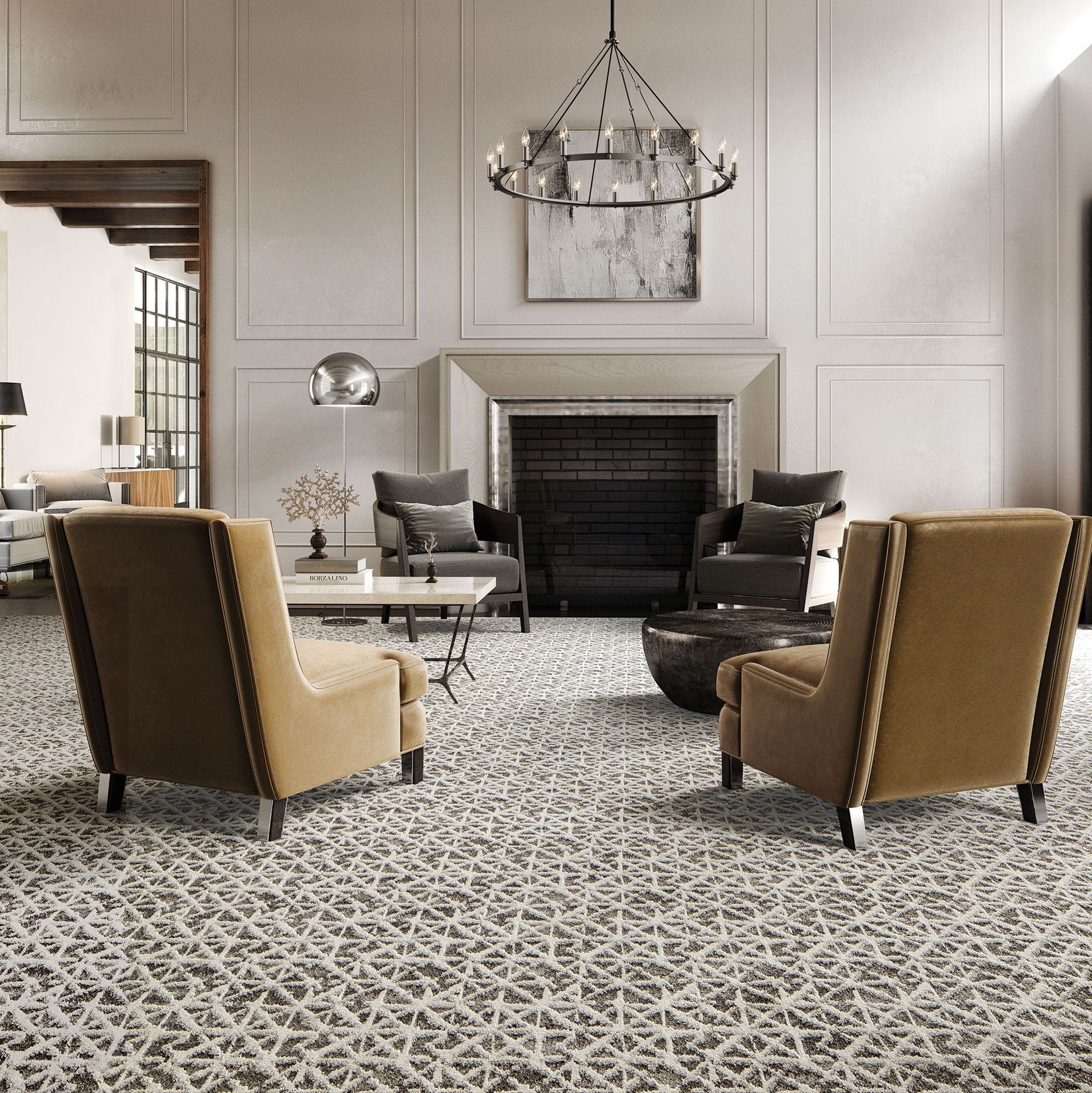 Elegant living room with patterned carpet, fireplace, chandelier, and two tan armchairs facing a dark sofa.