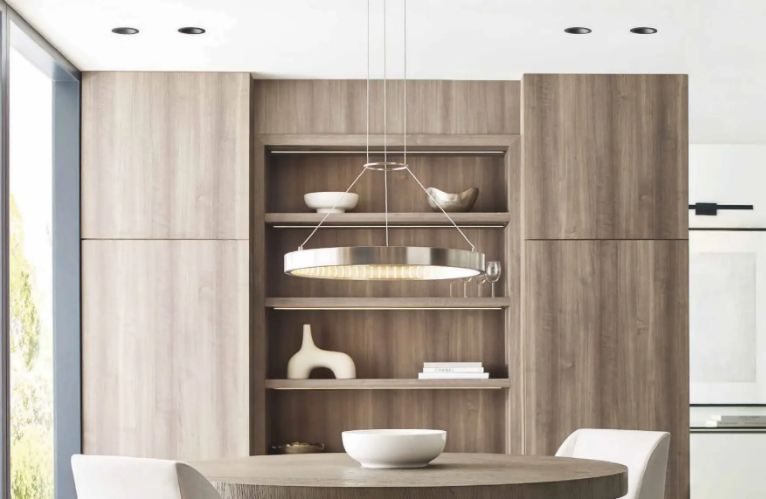 Modern kitchen with wood cabinetry, open shelves, round dining table, and white pendant lights
