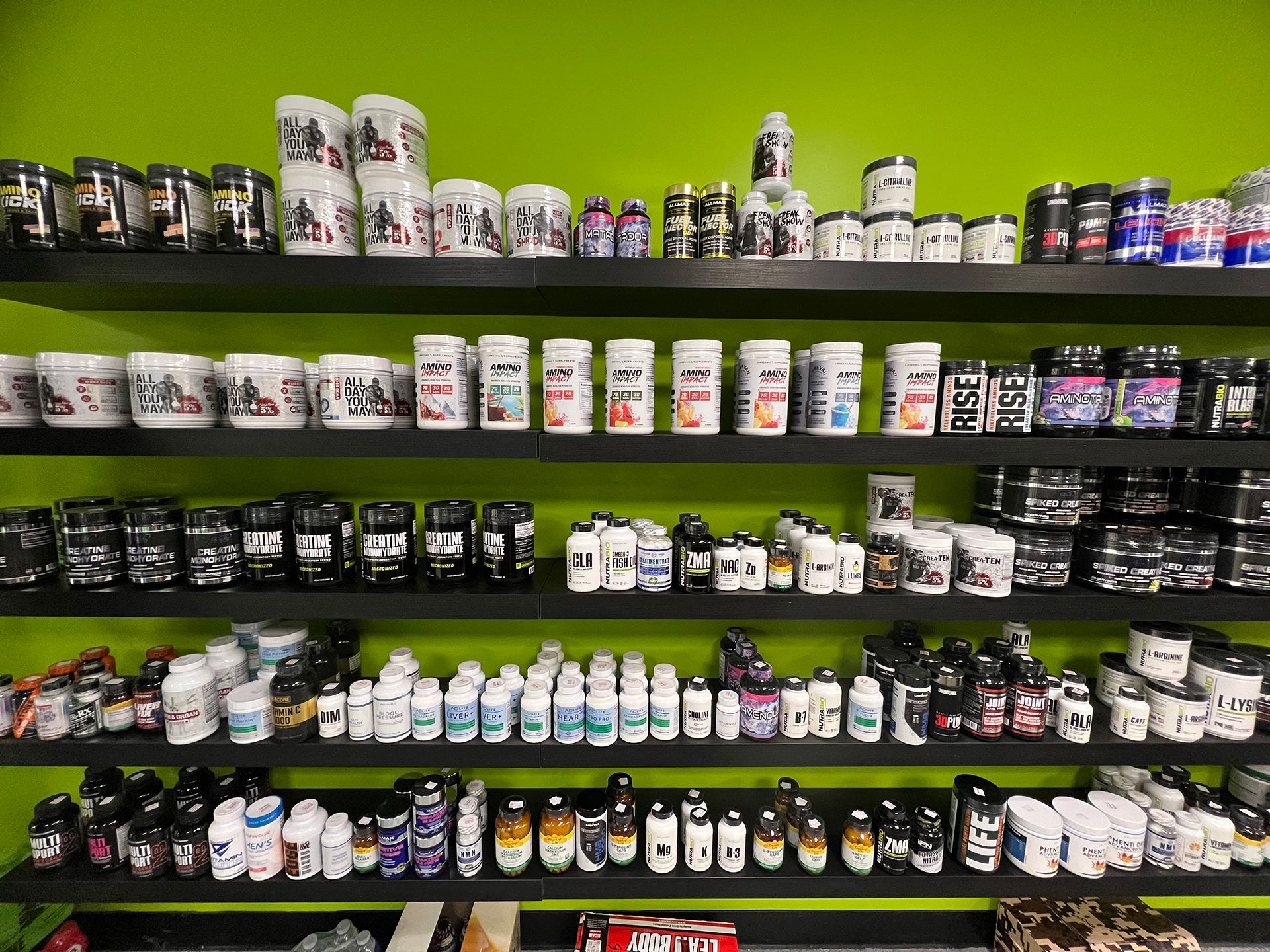 A store shelf filled with lots of different types of supplements.