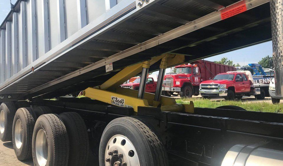 A dump truck is parked on the side of the road.