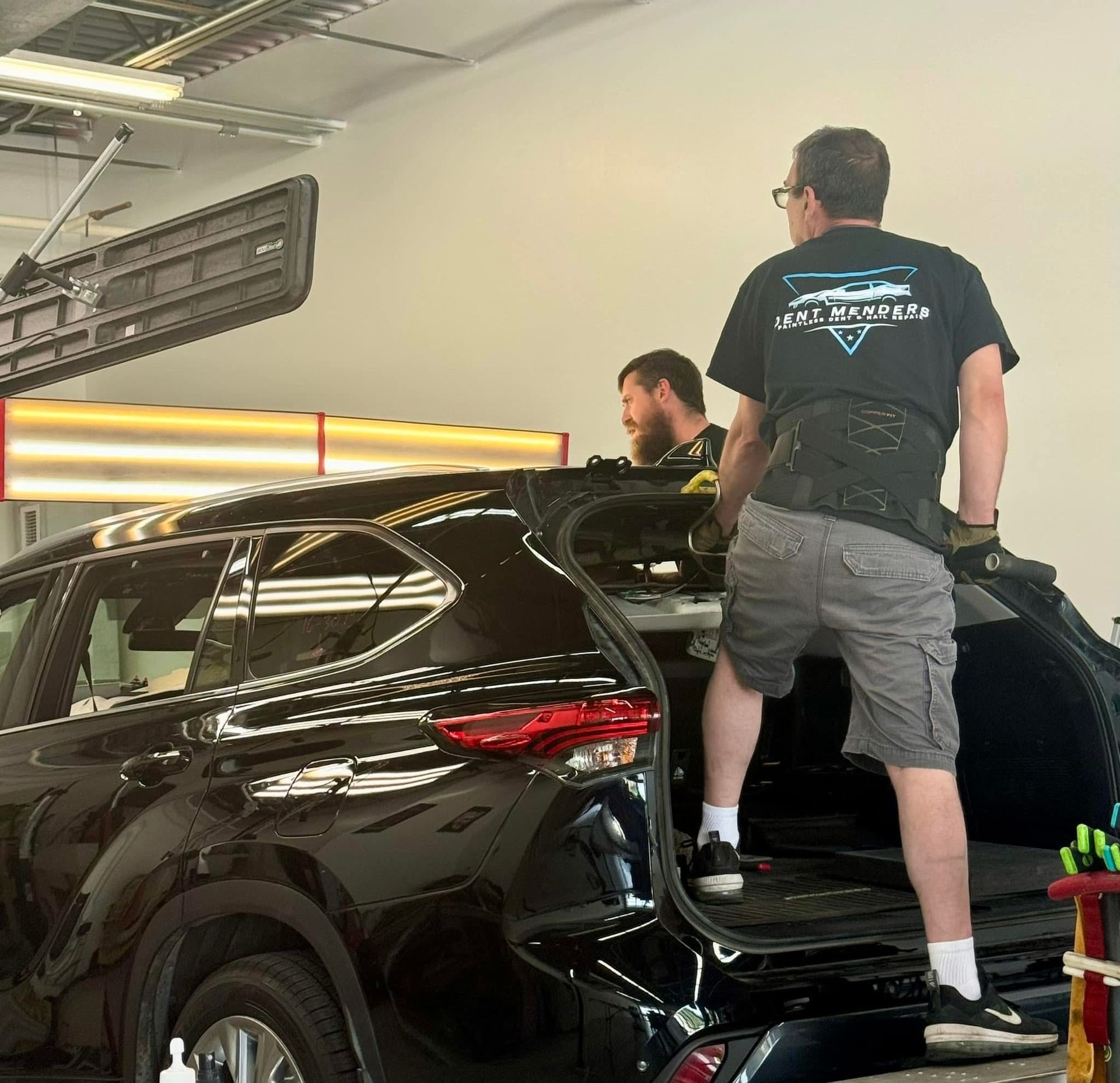 A man wearing a shirt that says less insurance on the back