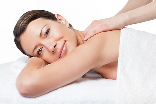 A woman is laying on a massage table getting a massage.