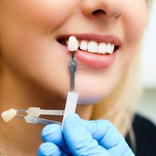 A woman is getting her teeth examined by a dentist