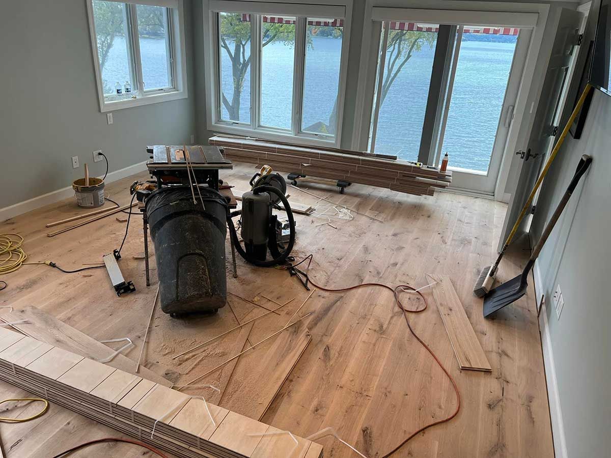 A room with a lot of windows and a wooden floor.