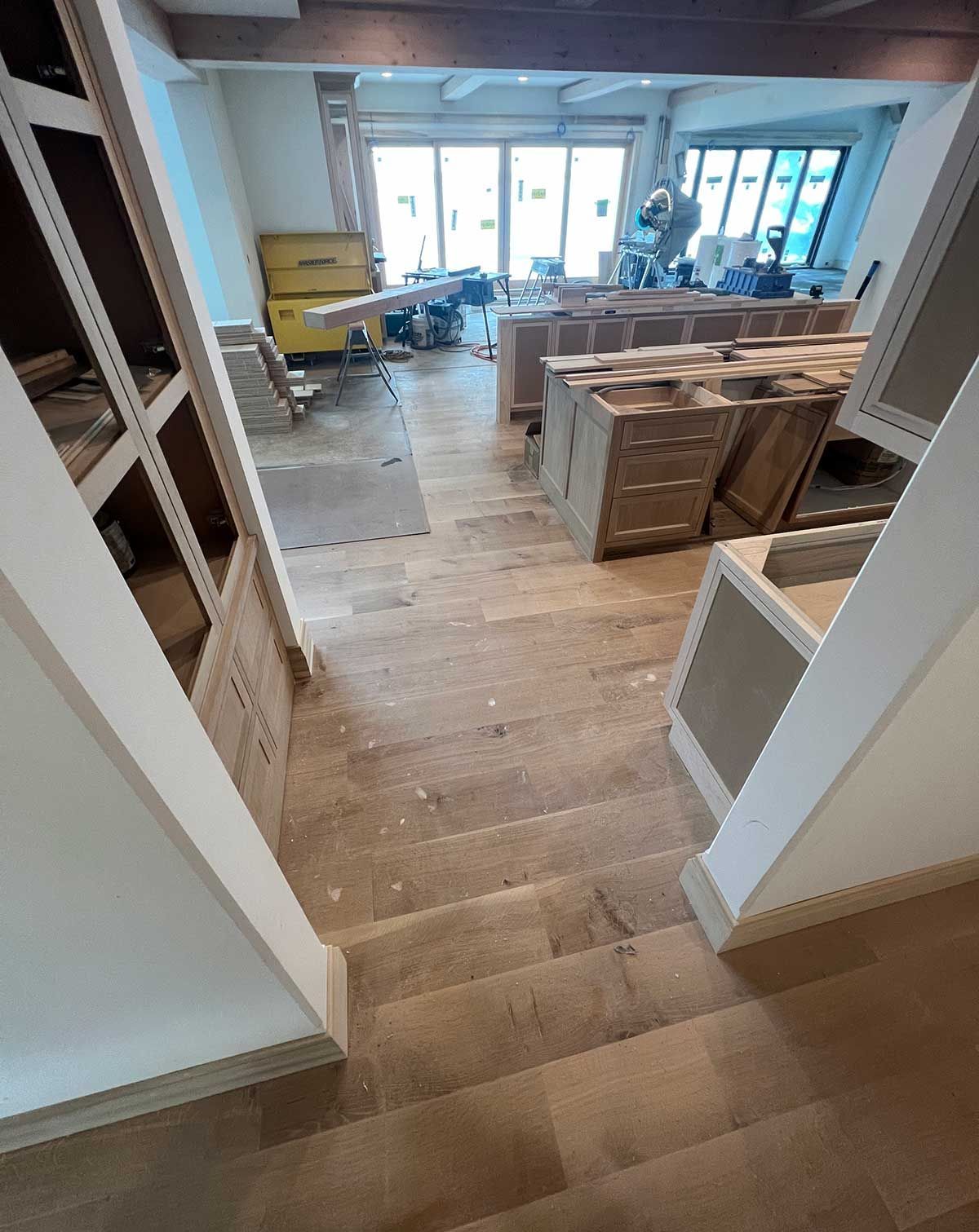 A staircase leading up to a living room in a house under construction.