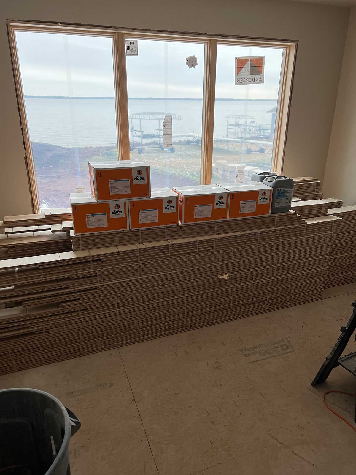 A room with boxes stacked on top of each other in front of a window.