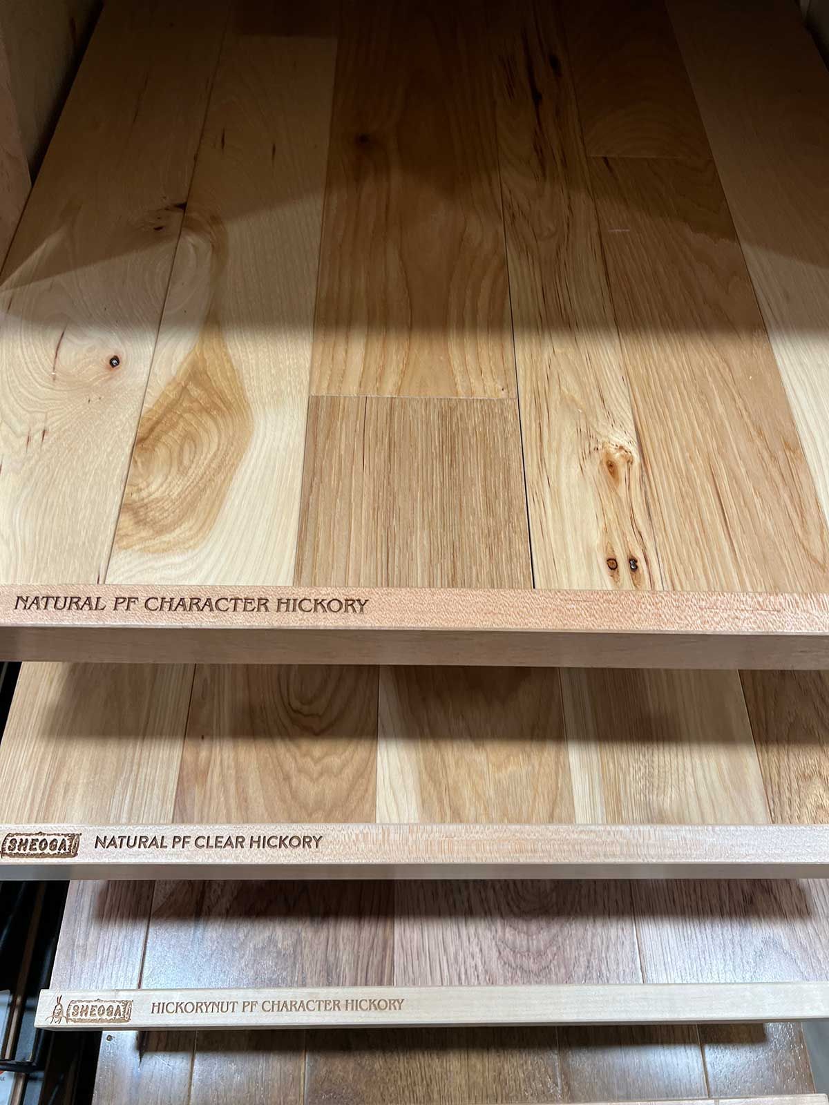 A stack of wooden boards sitting on top of each other on a shelf.