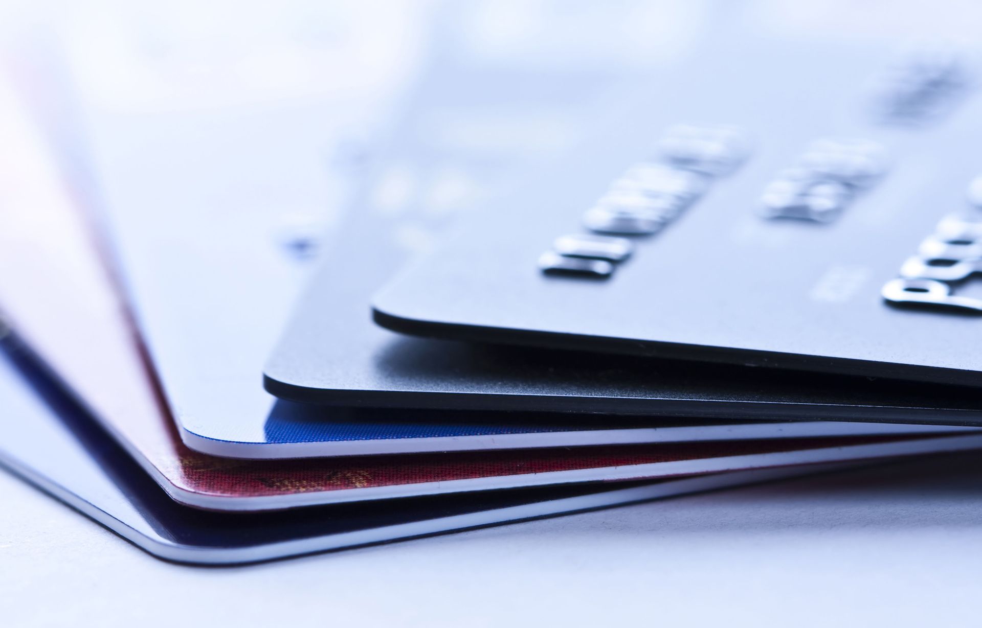 Several credit cards are stacked on top of each other
