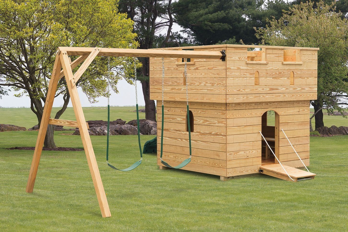 A wooden playhouse with a swing set attached to it