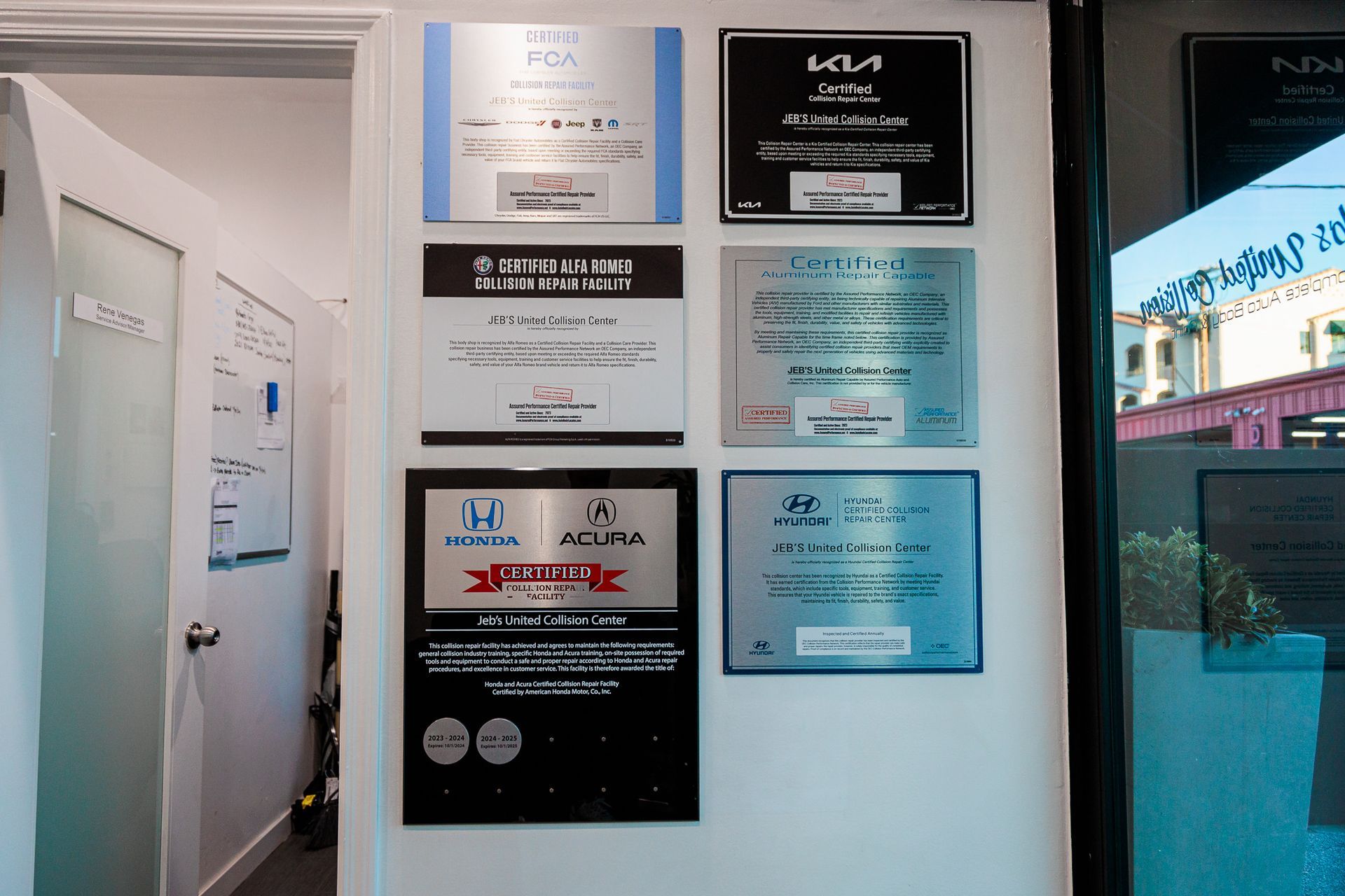 A wall with a bunch of plaques on it including one that says acura