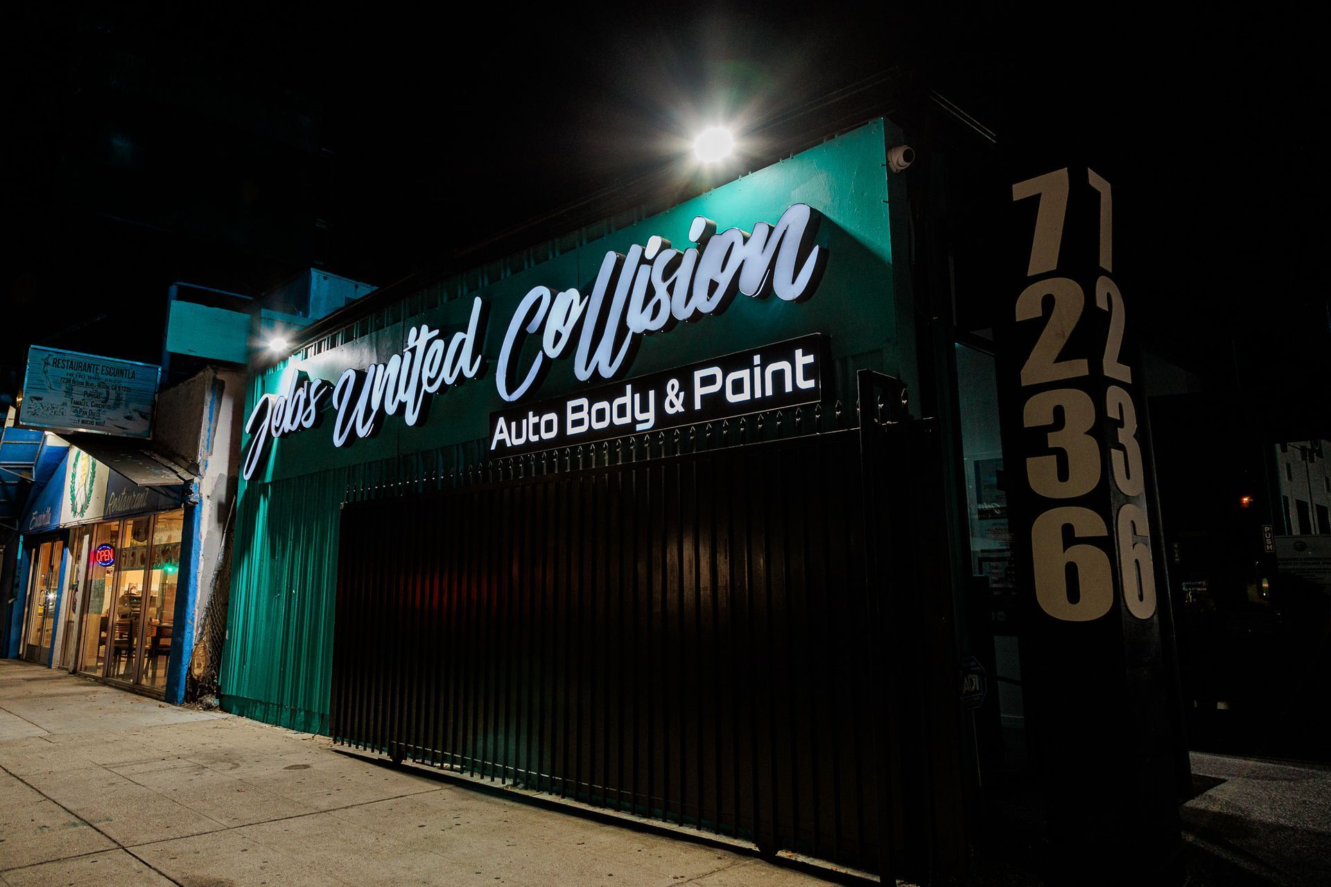 A green building with the word collision on it