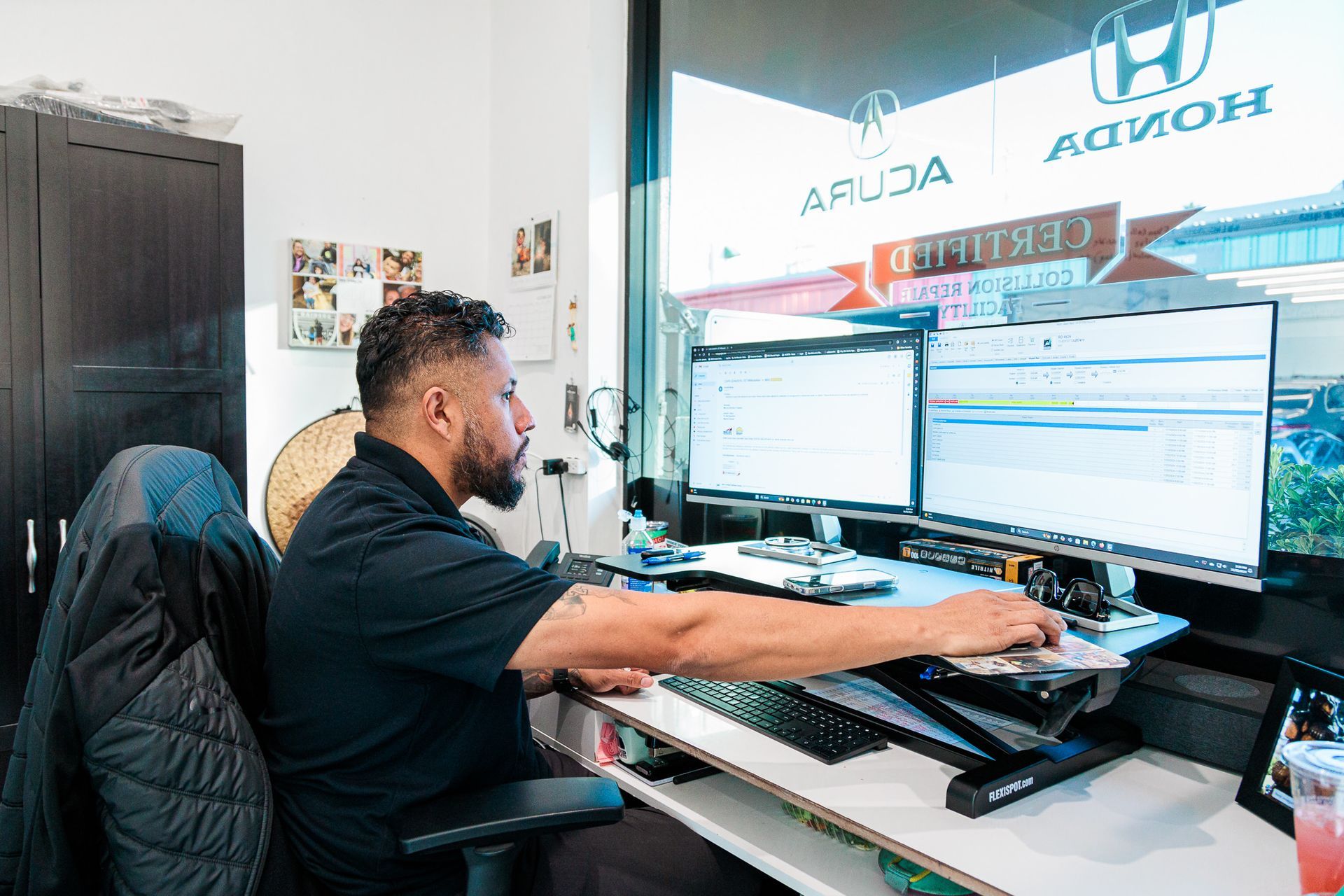 A man is sitting at a desk in front of a computer.