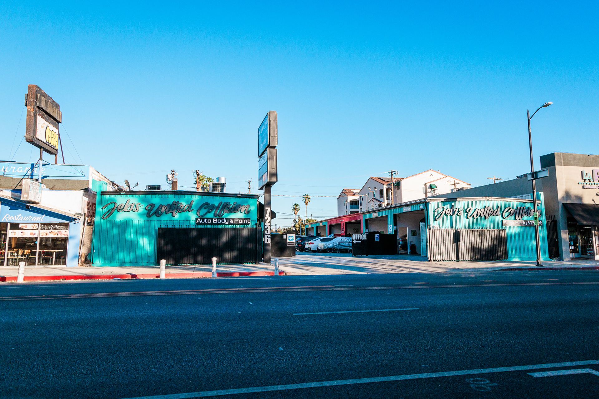 A street with a lot of cars parked on the side of it