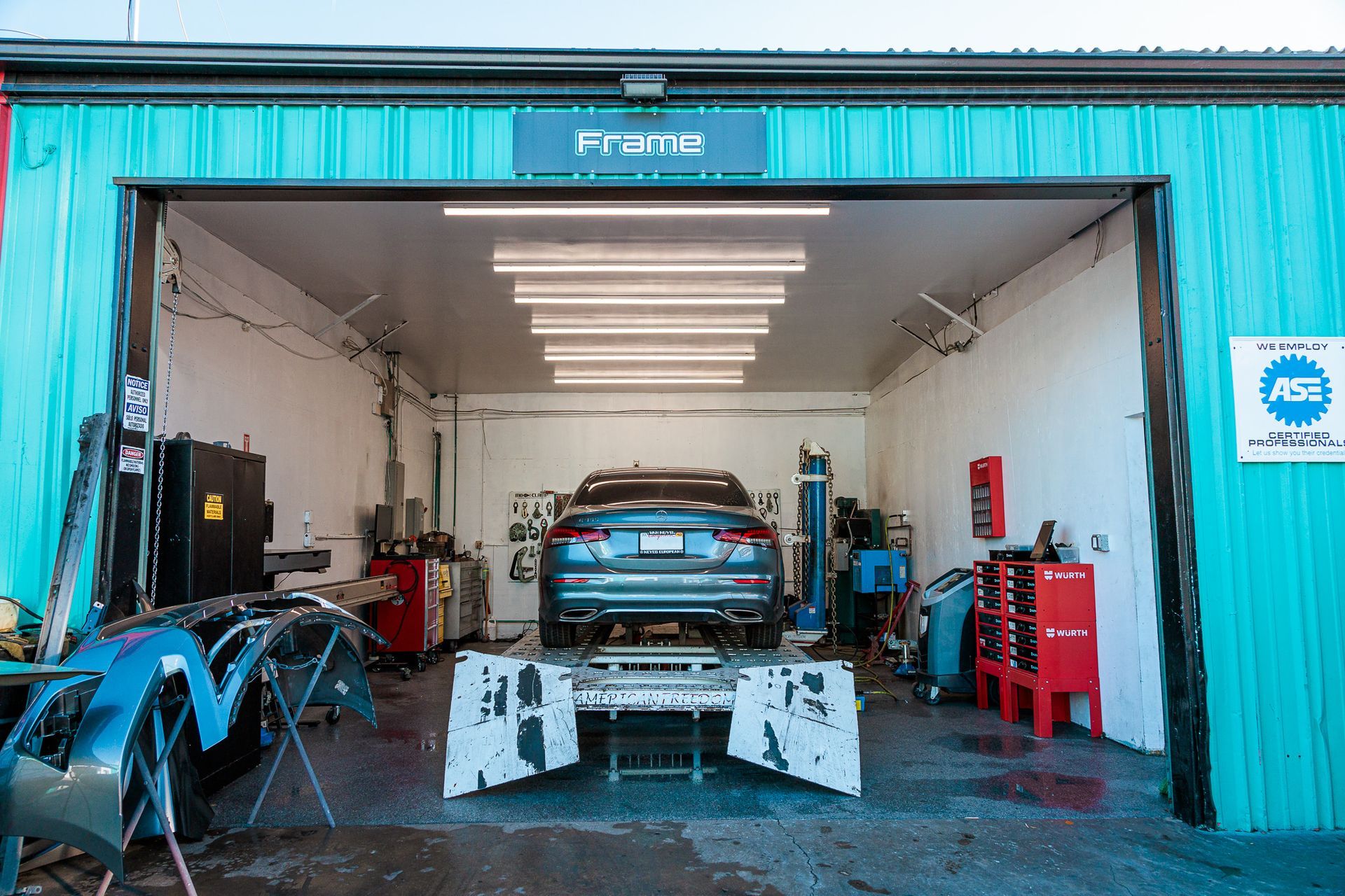A car is being worked on in a garage.