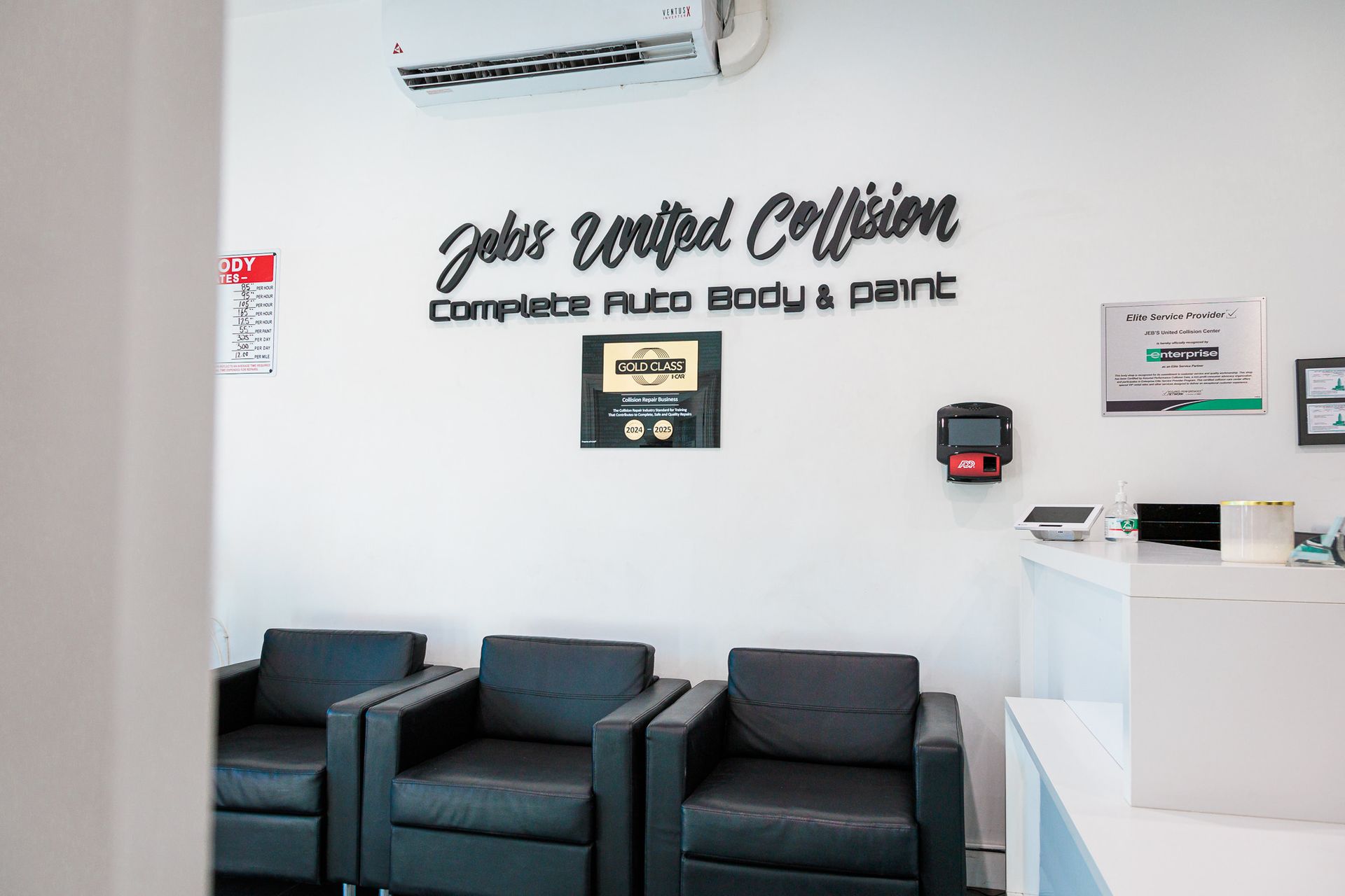 A waiting room with chairs and a sign on the wall that says Jebs United Collision Center