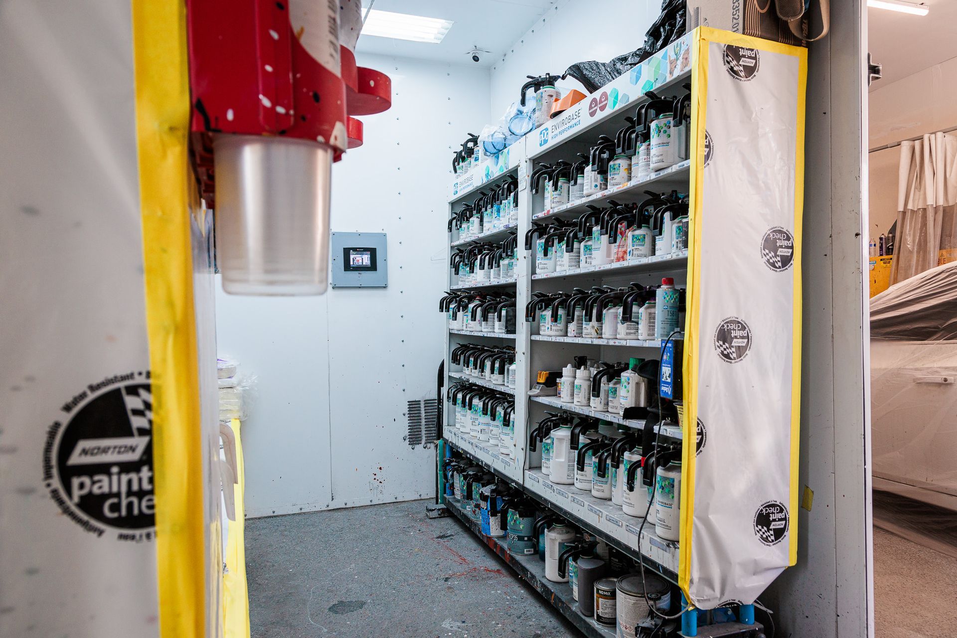 A room filled with shelves filled with lots of paint.