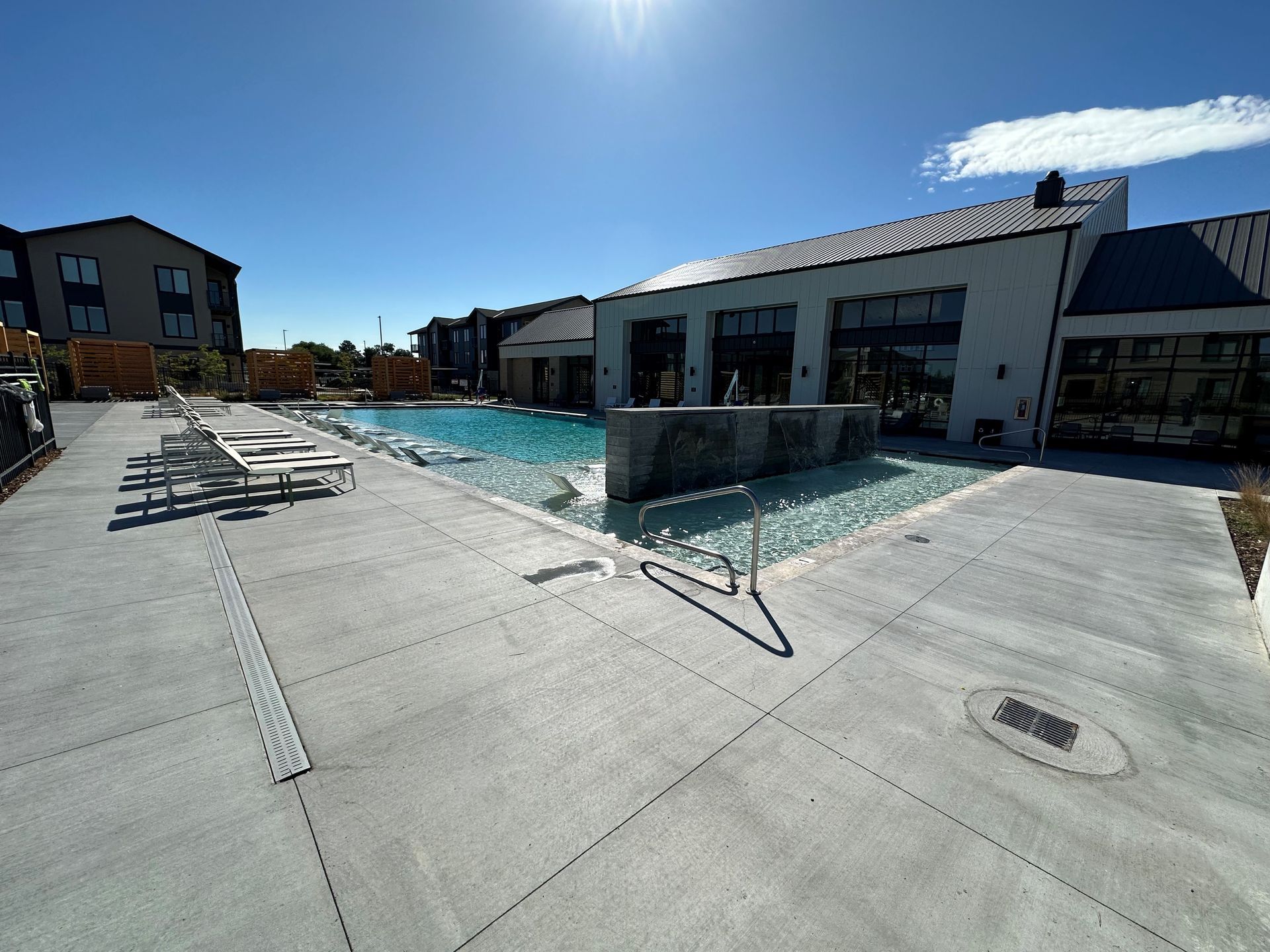 A large swimming pool in front of a building.